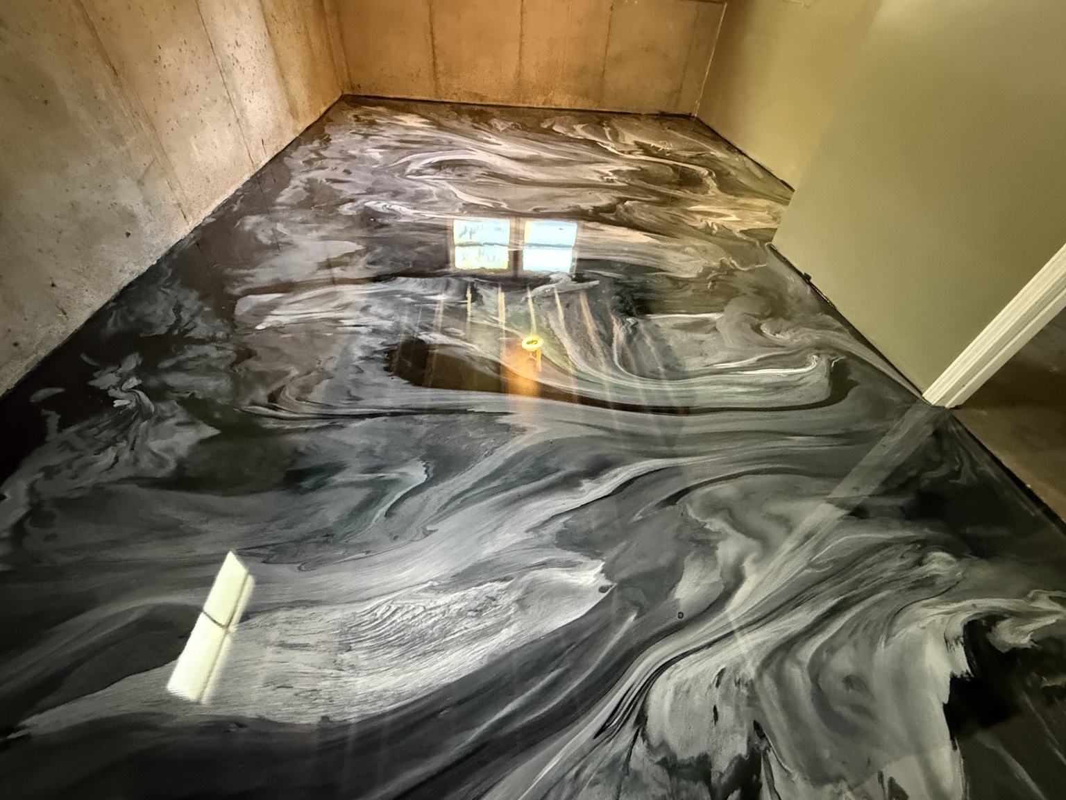 Black and silver metallic floor with flowing pattern across a room