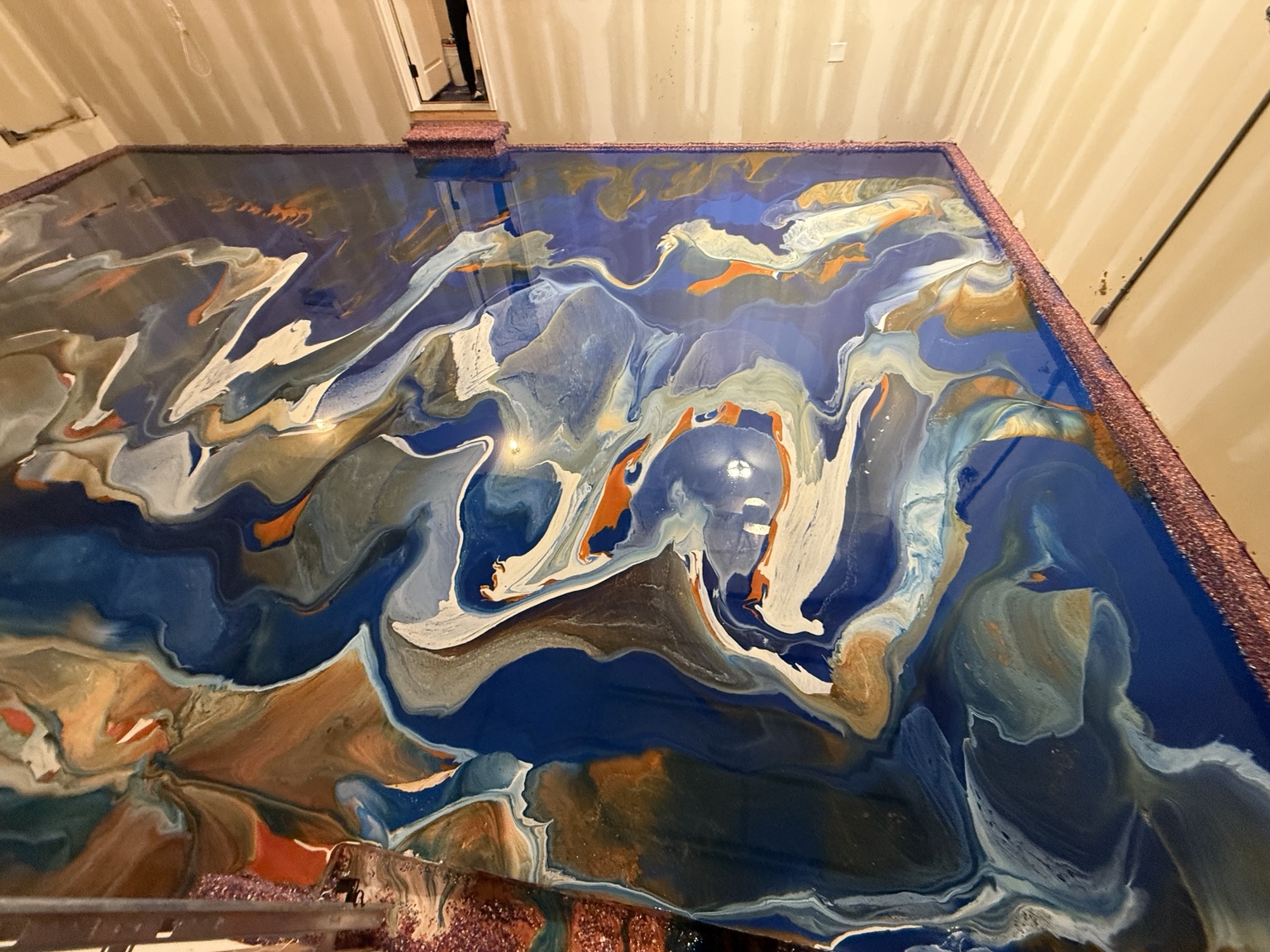 Closer view of flowing colors in the blue metallic garage floor