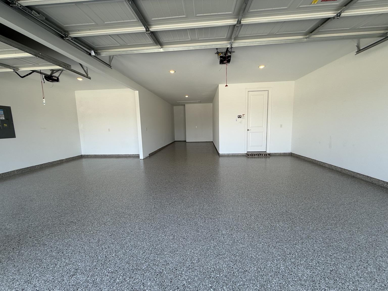 Wide view of the finished gray flake garage floor and coated perimeter